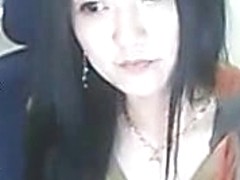 Adorable Asian babe smokes cigarette and demonstrates her boobs