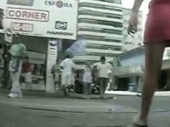 Cute bimbo in pink skirt caught on upskirt video on the street