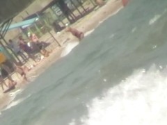 Nice babes are being filmed on camera on the beach