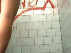 A brunette model goes to the pool bathroom to take a huge shit