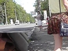 Upskirting young girlfriend that is waiting for a bus